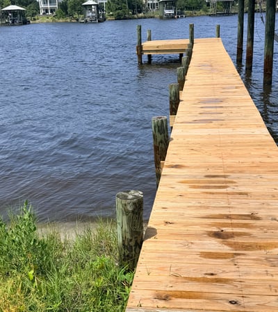 Inviting waterfront property featuring a spacious dock, perfect for boating and enjoying scenic water views.