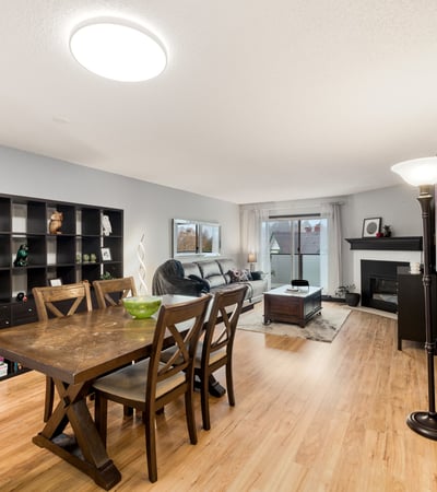 Bright, open living space featuring a cozy fireplace and modern dining area with ample natural light.