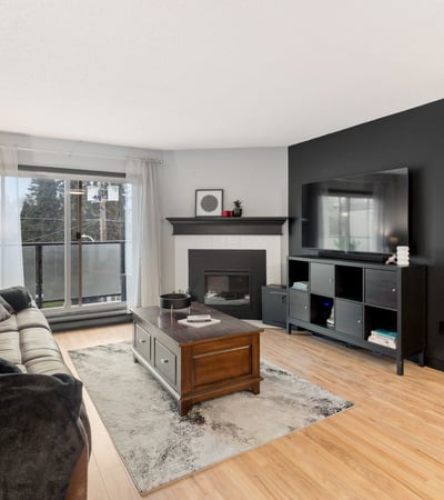 Bright living area featuring a cozy fireplace and modern decor, perfect for relaxation and entertaining.