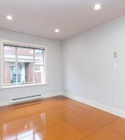 Bright and open space featuring large windows, perfect for personalizing as a cozy living area or studio.
