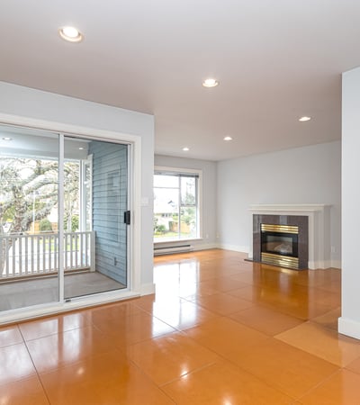 Bright and airy living space featuring a cozy fireplace and direct access to outdoor views.