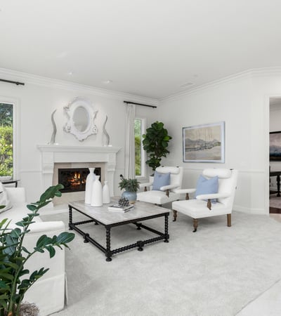 living space features a cozy fireplace and large windows, perfect for relaxation and gatherings.