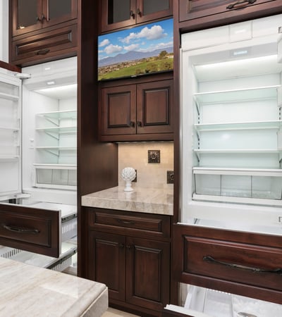 This gourmet kitchen features dual Sub Zero refrigerators, 4 pull out freezer drawers with ample storage, fun appliance garage and modern finishes for culinary enthusiasts.