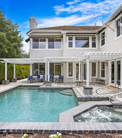 This inviting backyard features a spacious pool and spa, perfect for entertaining and relaxation.