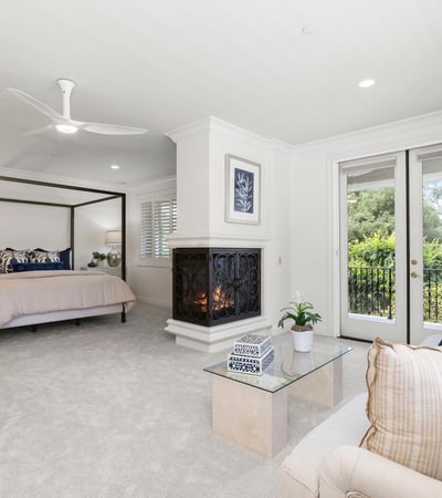 Bedroom 3-Spacious Primary bedroom suite featuring a cozy fireplace and direct access to a private balcony with private views galore
