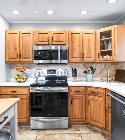 Charming kitchen with warm wood accents, Corian counters.