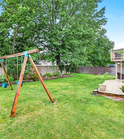 Spacious yard with swing set charm.