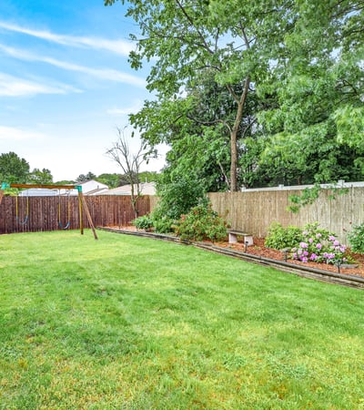 Backyard oasis with flower beds.