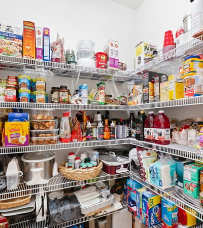 Spacious pantry with ample shelving, ideal for organized storage of food and household essentials.
