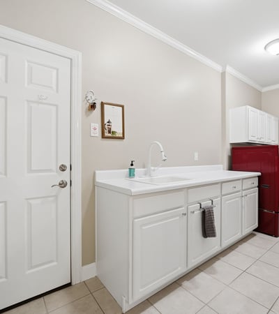 Spacious laundry room featuring ample counter space and modern appliances for efficient household tasks.