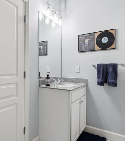 Bright and functional bathroom featuring modern fixtures, a spacious countertop, and contemporary decor.