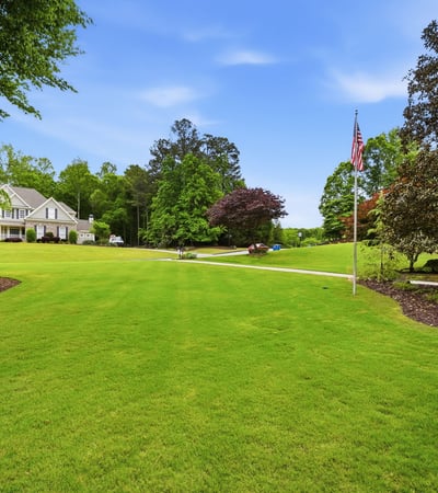 Expansive, well-maintained grounds offer ample space for outdoor activities and potential landscaping projects.