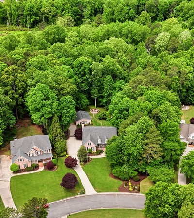 Discover a landscaped community nestled among lush greenery, offering privacy and a peaceful suburban lifestyle.