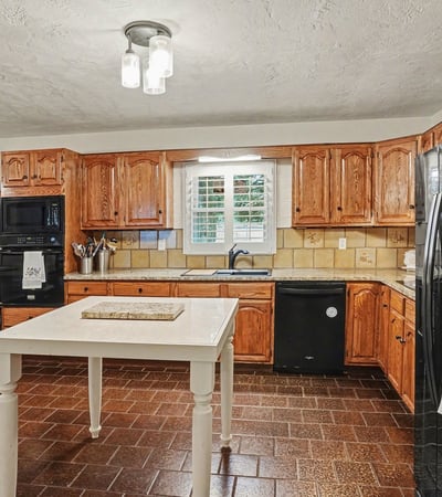 Kitchen with refinished real wood cabinets and new granite countertops.