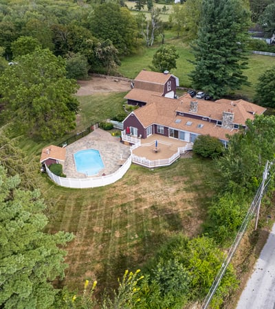 Spacious property featuring a pool, surrounded by lush greenery, perfect for outdoor activities and relaxation.