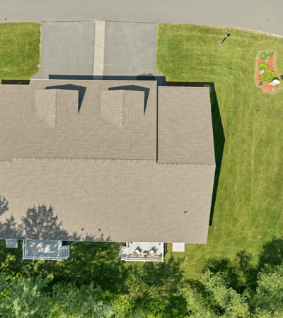 Spacious lot with well-maintained landscaping, featuring a welcoming outdoor space and convenient driveway access.
