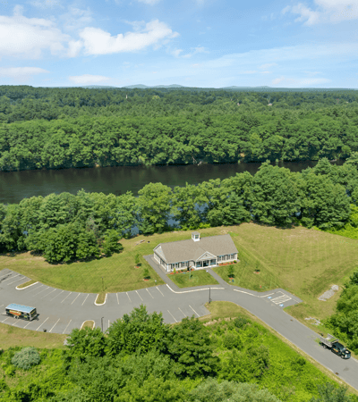 Spacious property with expansive parking and scenic river views, ideal for development or recreational use.