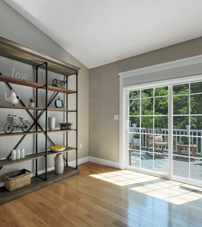 Bright living space featuring a modern open layout and large sliding doors leading to a private deck.