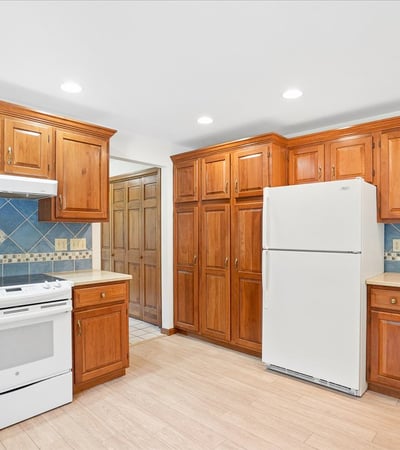 Discover a bright kitchen featuring ample cabinetry, modern appliances, and a functional layout perfect for cooking.