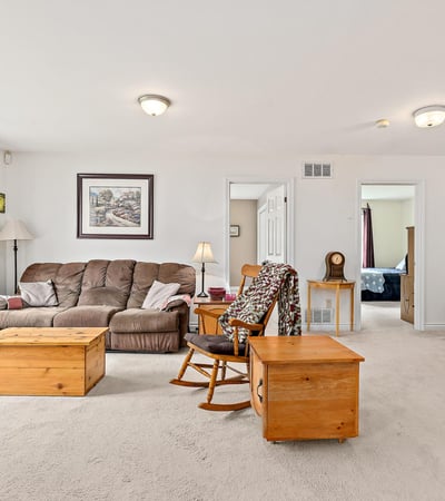Spacious living area featuring natural light, modern furnishings, and versatile layout for comfort and functionality.