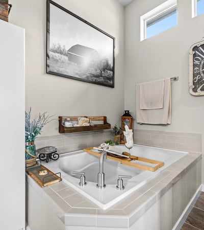 Primary Suite with attached 5 piece bath and walk in closet.