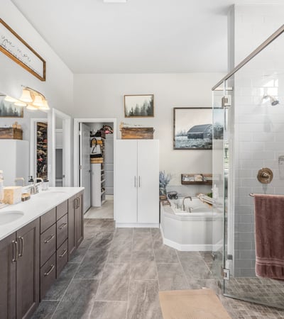 Primary Suite with attached 5 piece bath and walk in closet.
