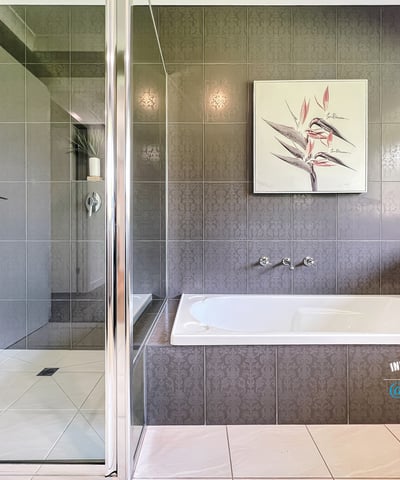 Spacious bathroom featuring a double vanity, modern shower, and relaxing bathtub for ultimate comfort.