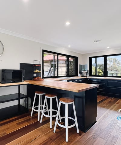 Bright and functional kitchen featuring modern appliances, ample counter space, and scenic views through expansive windows.