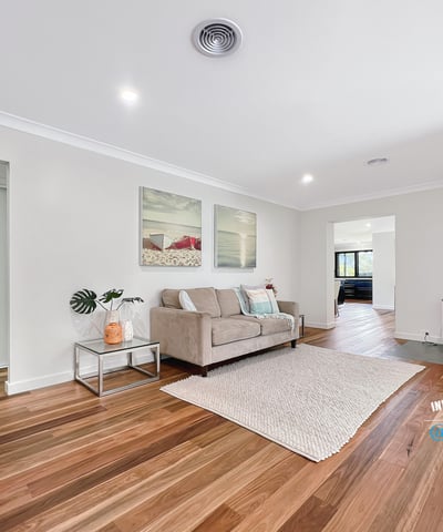 Spacious living area featuring hardwood floors and a cozy wood-burning stove, perfect for gatherings and relaxation.