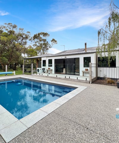 This spacious property features a large pool and versatile outdoor space, ideal for entertaining and relaxation.