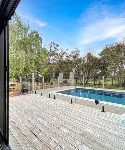 Spacious indoor-outdoor living with modern pool views, surrounded by lush greenery and serene landscapes.