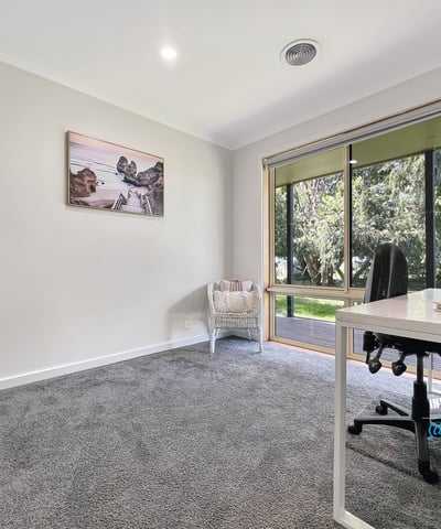 Bright and spacious room with large windows, offering peaceful views and ample natural light for productivity.
