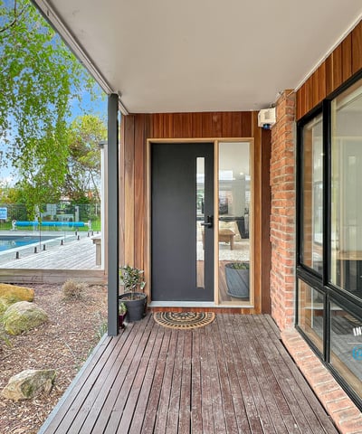 Discover modern living with a seamless indoor-outdoor flow, featuring a sleek entry and inviting surroundings.