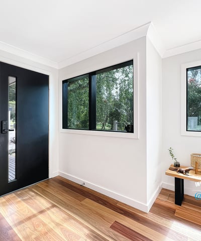 Bright entryway featuring large windows and natural light, welcoming you into a spacious home.