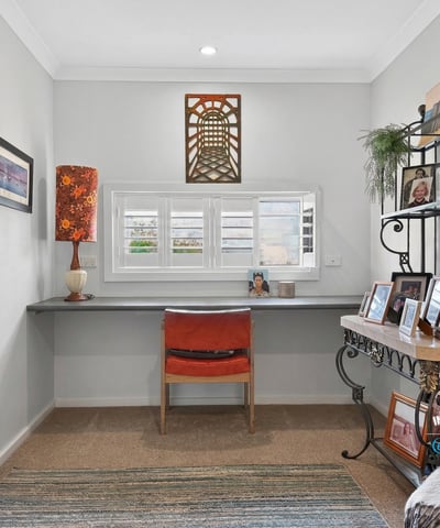 Bright and airy workspace featuring a modern desk, natural light, and personalized decor for inspiration.