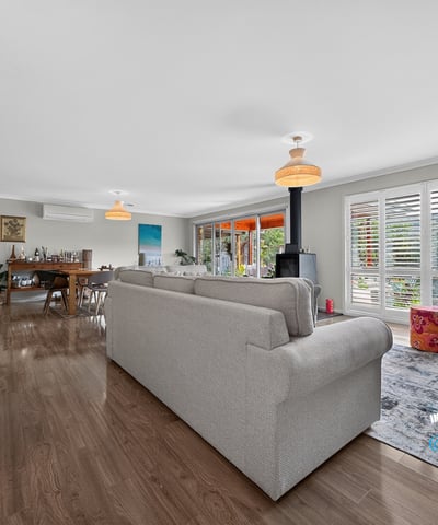 Spacious open-concept living area with abundant natural light, featuring modern decor and inviting spaces for gatherings.
