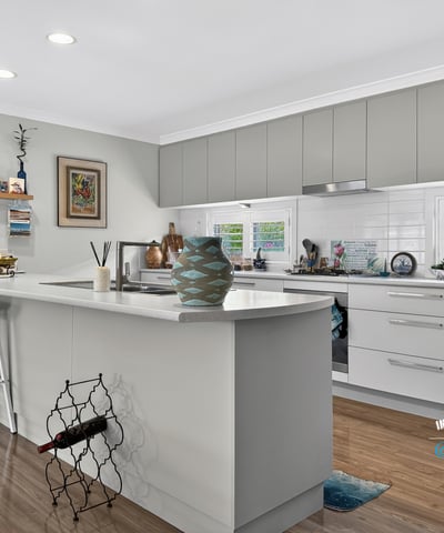 Modern kitchen featuring ample storage, sleek cabinetry, and a functional island, perfect for culinary enthusiasts.