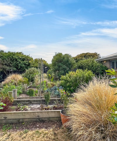 Lush, well-maintained garden beds invite gardening enthusiasts to cultivate their dreams in this vibrant outdoor space.