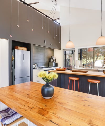 Modern kitchen featuring a spacious island, sleek appliances, and ample natural light for vibrant gatherings.
