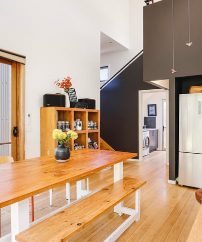 Modern kitchen with open layout, featuring natural light, wooden accents, and a functional design for gatherings.