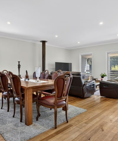 Spacious open-concept living and dining area with abundant natural light and direct access to the patio.