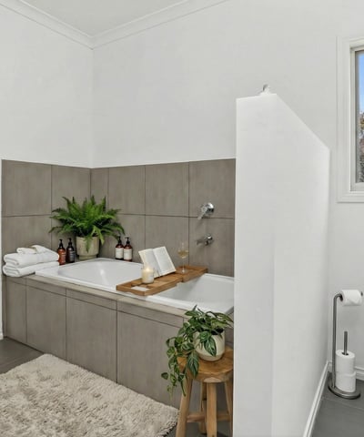 This inviting bathroom features a spacious tub, modern fixtures, and natural light for a refreshing experience.