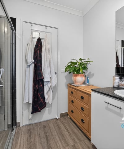 Modern bathroom featuring sleek finishes, a spacious shower, and ample storage for convenience and organization.