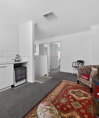 Spacious living area with kitchenette and versatile layout, perfect for personalized interior design and cozy gatherings.