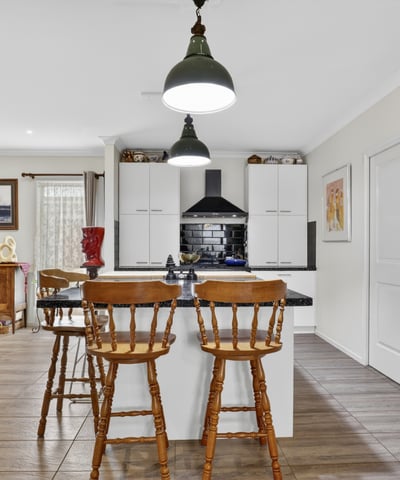Modern kitchen with ample storage, featuring a central island and inviting dining area for casual meals.