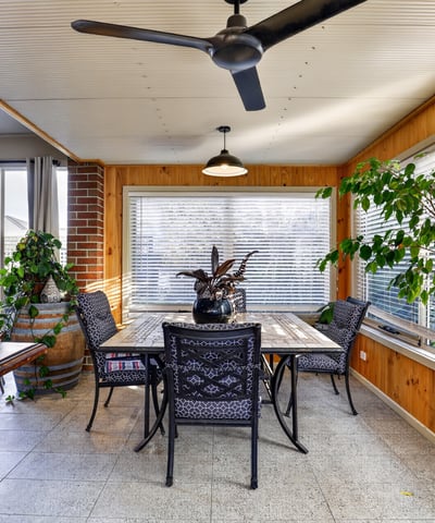 Bright and airy sunroom features large windows, perfect for enjoying peaceful views and entertaining guests.