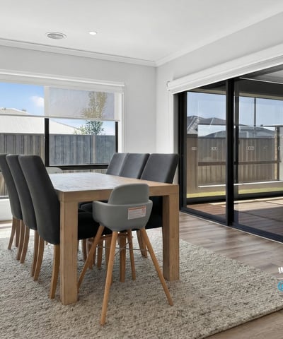 Spacious dining area features large windows and seamless indoor-outdoor flow, perfect for entertaining.