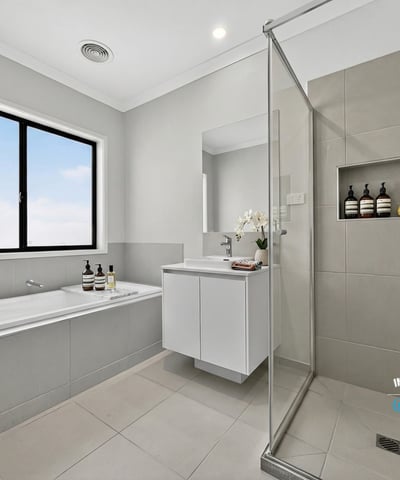 Modern bathroom featuring a glass shower, soaking tub, and sleek cabinetry for a contemporary finish.