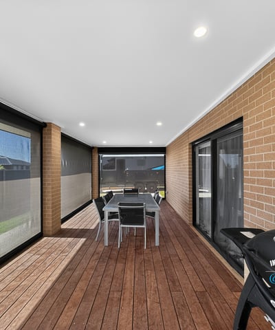 Spacious covered patio featuring outdoor dining and barbecue area, perfect for entertaining and enjoying the outdoors.