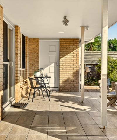 This inviting outdoor space features ample seating and natural light, perfect for relaxation and gatherings.